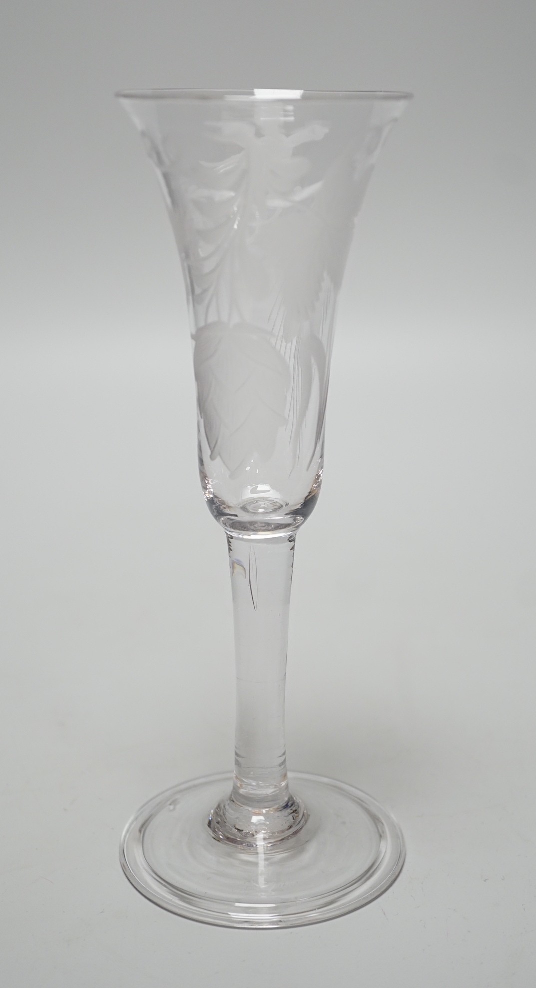 An 18th century engraved ale flute, folded foot, 19.5cms high